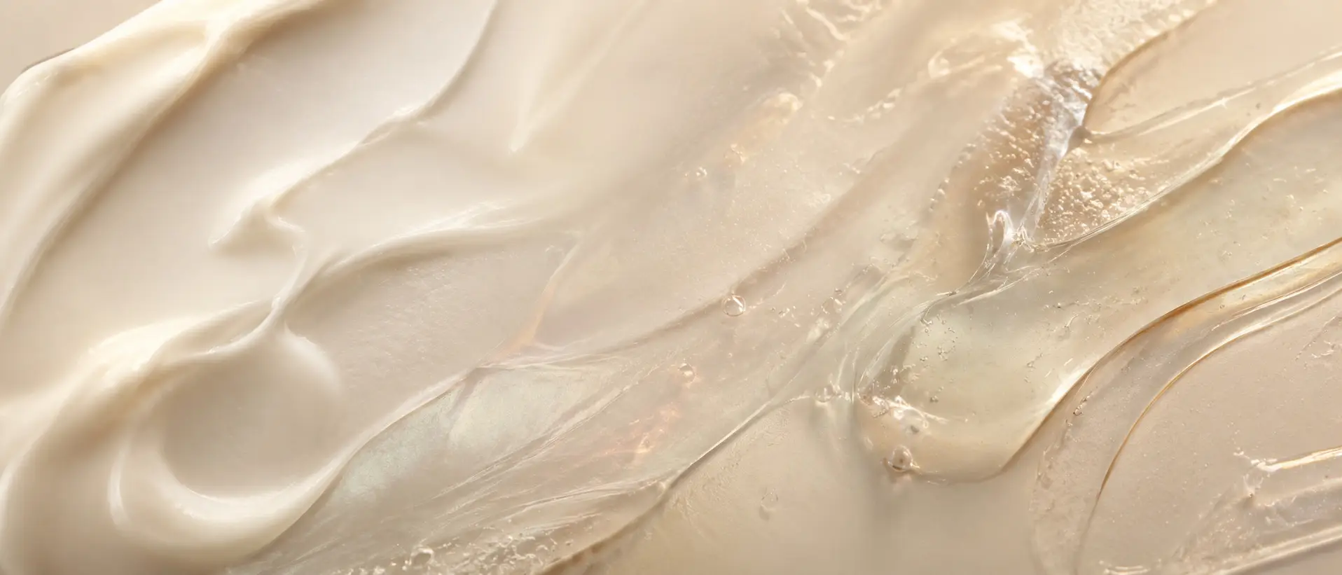 Close-up of cream and translucent gel cosmetic smears in warm beige tones